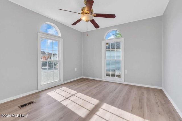 empty room with light hardwood / wood-style floors and ceiling fan