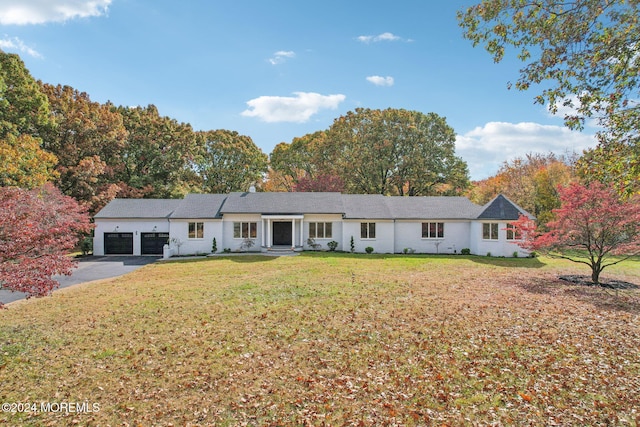 ranch-style house featuring a front yard and a garage