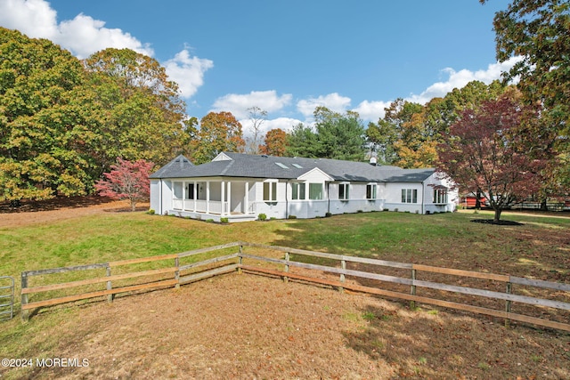 ranch-style home featuring covered porch and a front yard