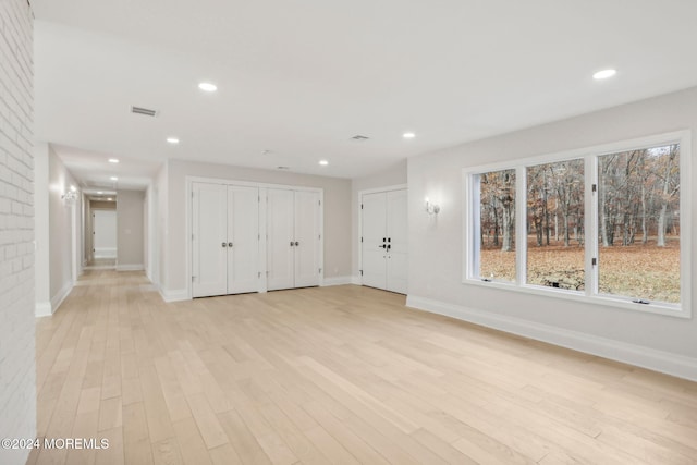 unfurnished living room featuring light wood-type flooring