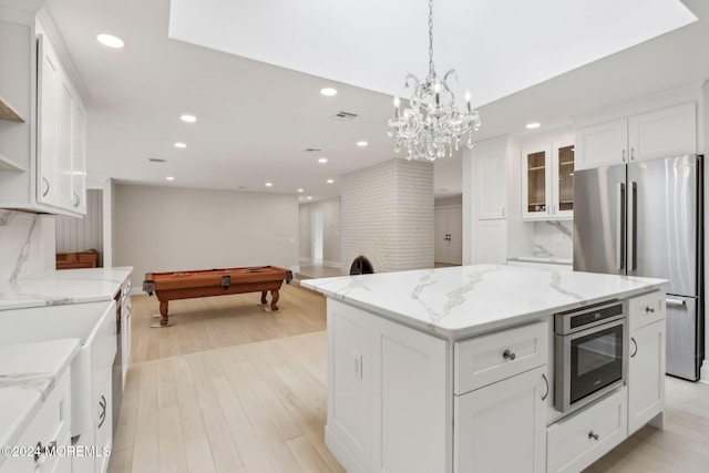 kitchen featuring a center island, billiards, white cabinets, and appliances with stainless steel finishes