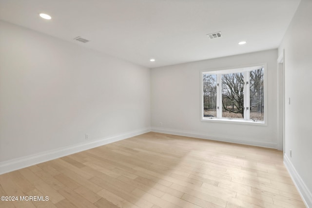 spare room with light hardwood / wood-style flooring