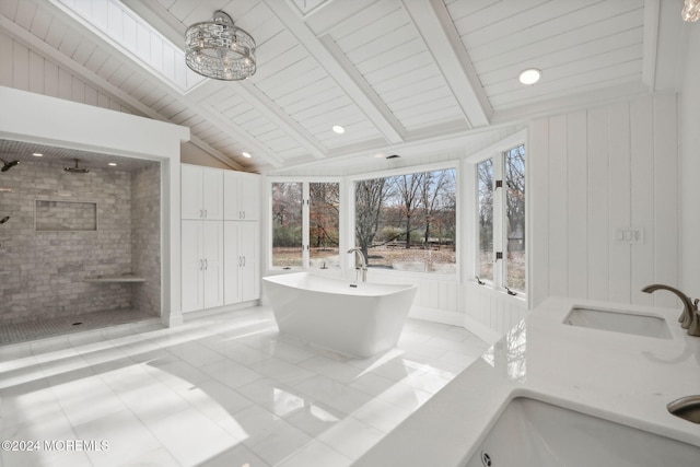 bathroom featuring separate shower and tub, tile patterned floors, lofted ceiling, and sink