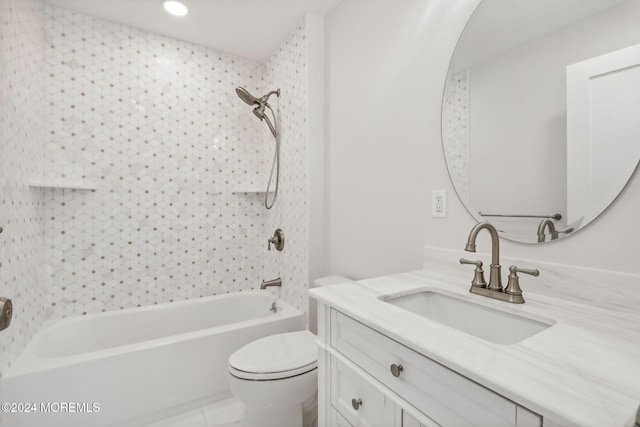 full bathroom featuring tile patterned floors, vanity, tiled shower / bath combo, and toilet