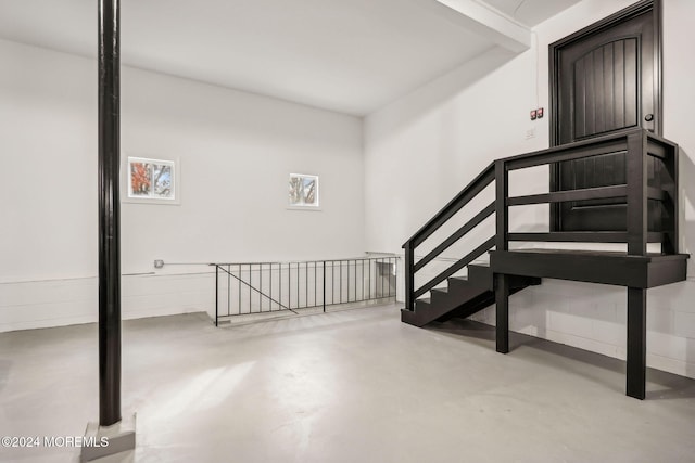 stairs featuring concrete floors