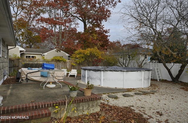 view of yard with a patio area and a covered pool