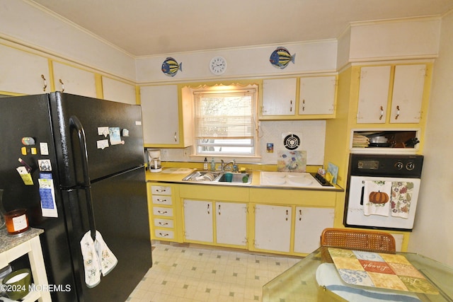 kitchen featuring black fridge, sink, and crown molding