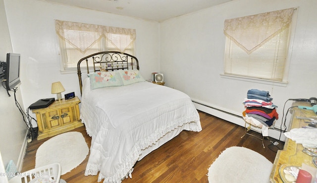 bedroom with dark hardwood / wood-style flooring and a baseboard radiator