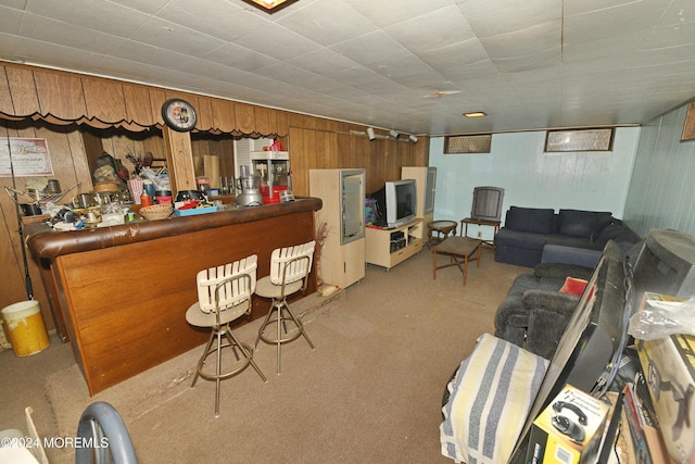 bar with light colored carpet and wood walls