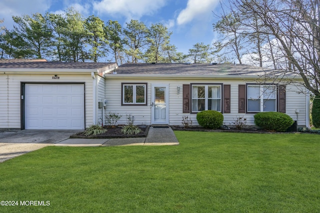 single story home with a garage and a front yard