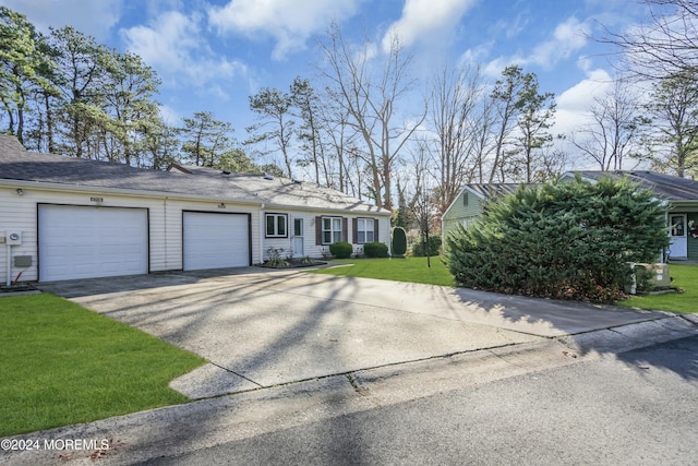 ranch-style home with a front yard and a garage