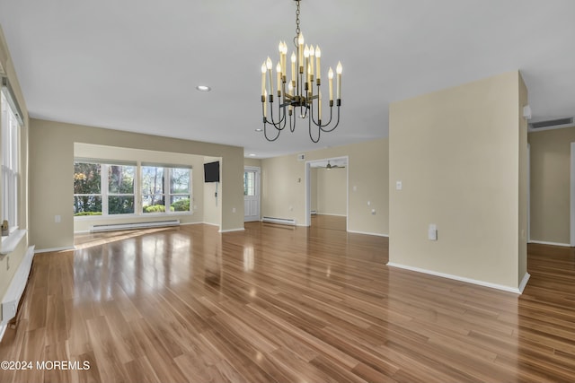 unfurnished living room with an inviting chandelier, light hardwood / wood-style floors, and a baseboard heating unit