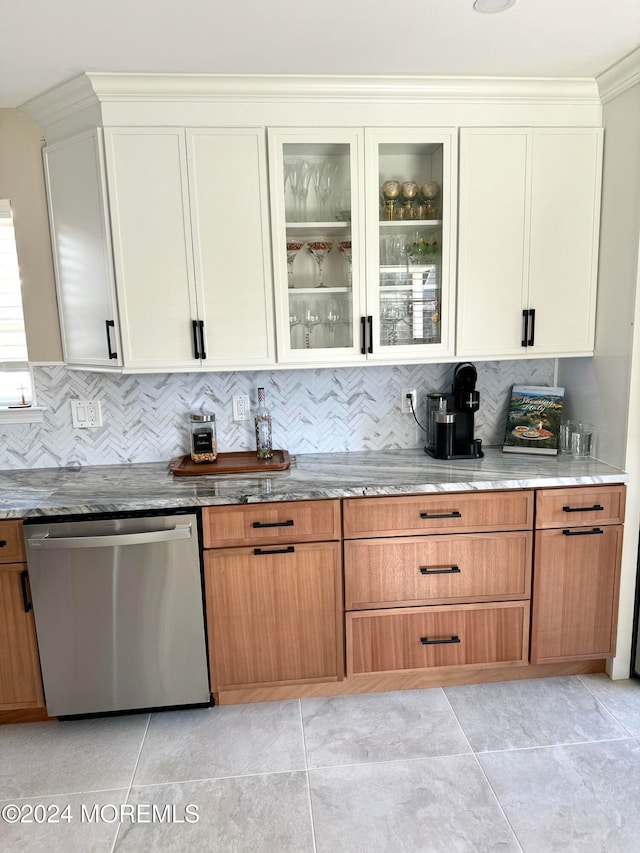 kitchen featuring decorative backsplash, dishwasher, white cabinets, and light tile patterned floors