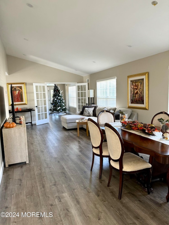 dining area with french doors, lofted ceiling, and wood-type flooring