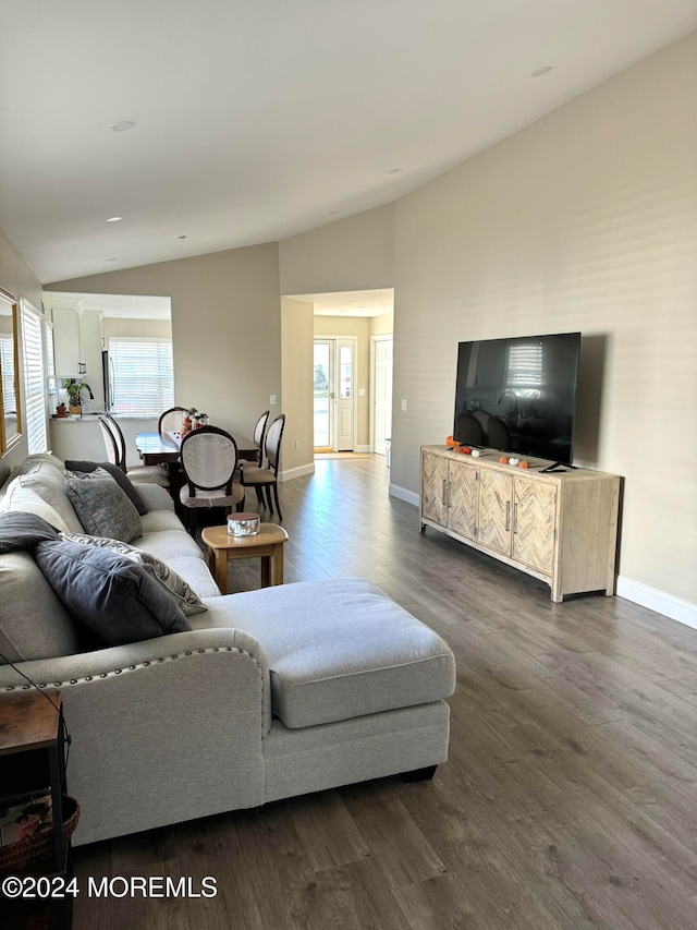 living room featuring dark hardwood / wood-style floors and lofted ceiling