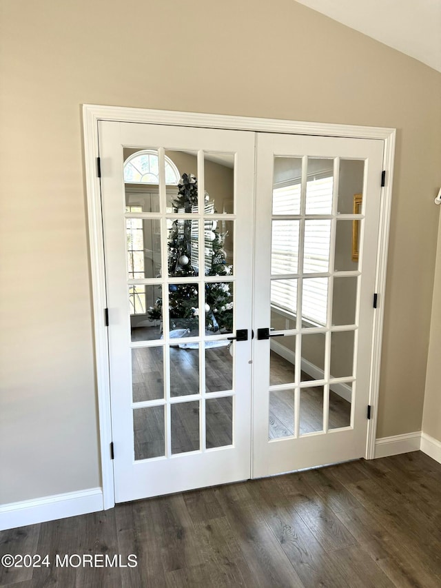 doorway featuring french doors, dark hardwood / wood-style floors, and lofted ceiling