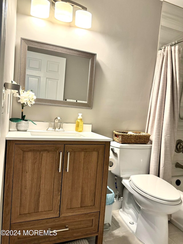 bathroom featuring tile patterned flooring, vanity, and toilet