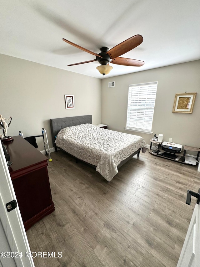 bedroom with ceiling fan and wood-type flooring