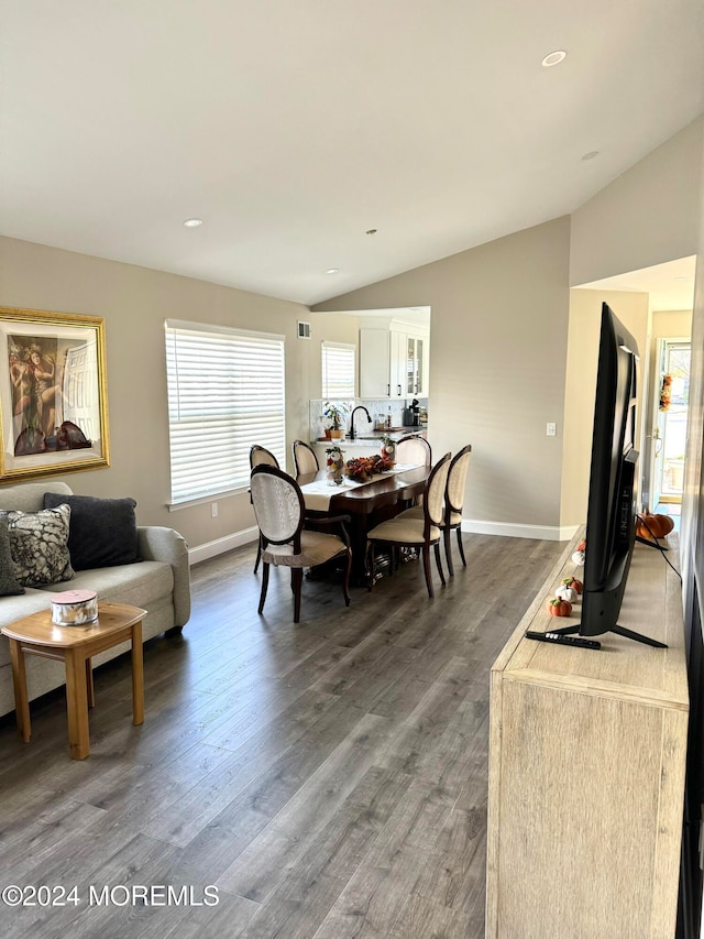 dining area featuring wood-type flooring and lofted ceiling