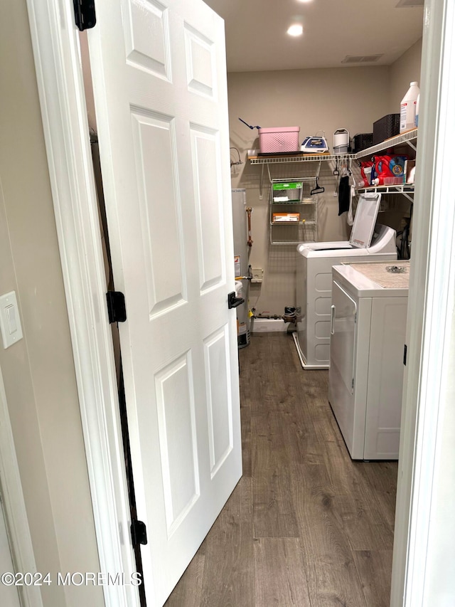 washroom featuring hardwood / wood-style floors and washer and dryer