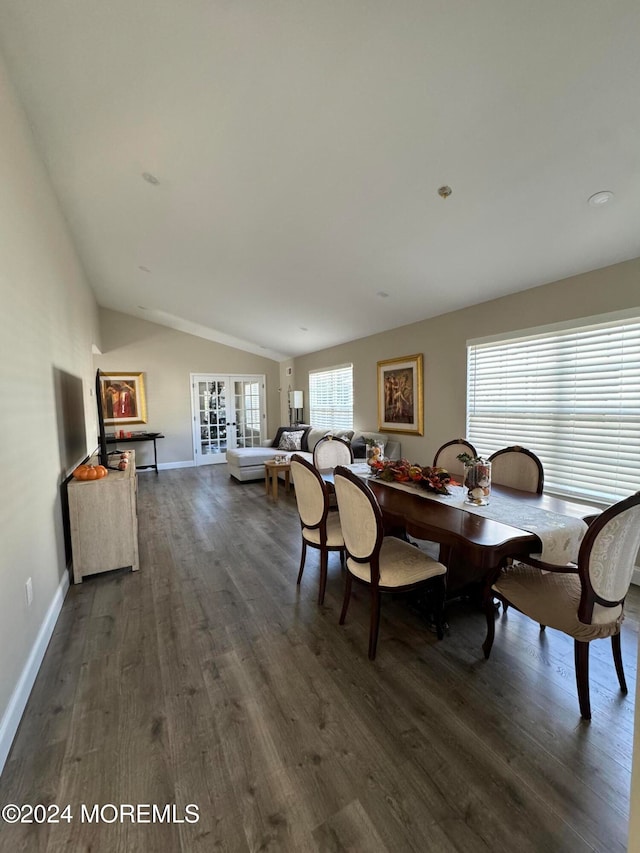 dining room featuring french doors, dark wood-type flooring, and vaulted ceiling