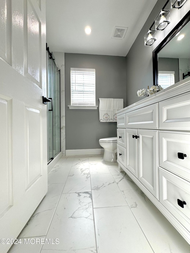 bathroom with toilet, an enclosed shower, and vanity