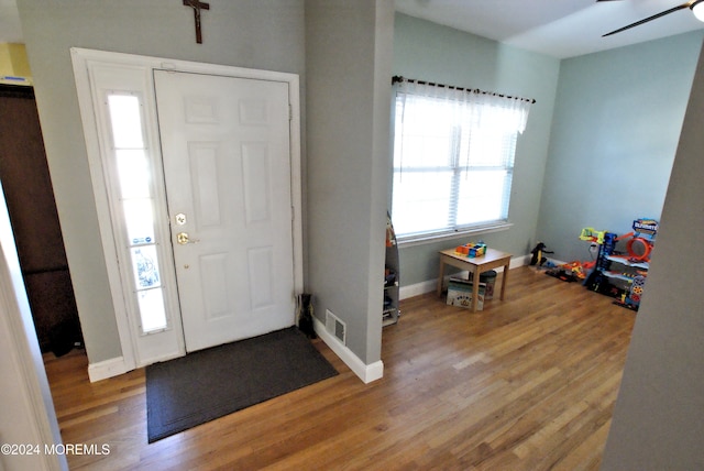 foyer entrance with ceiling fan and light hardwood / wood-style floors