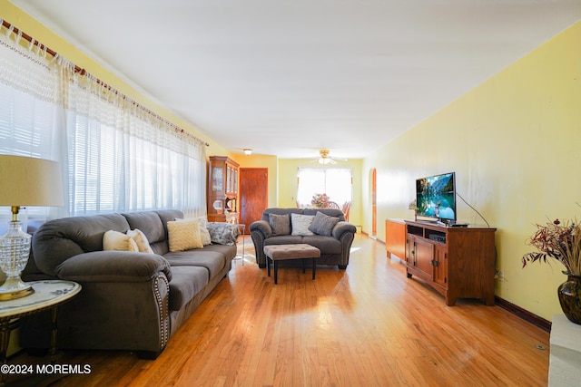 living room featuring ceiling fan and light hardwood / wood-style flooring