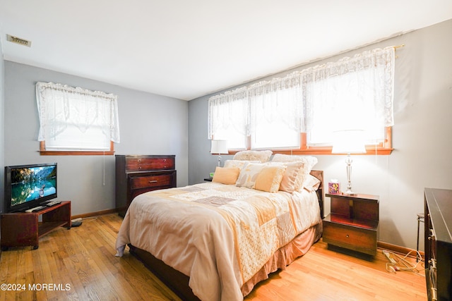 bedroom with wood-type flooring