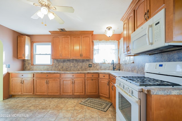 kitchen featuring tasteful backsplash, white appliances, ceiling fan, sink, and light tile patterned floors