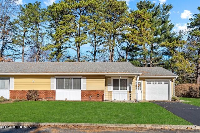 ranch-style home featuring a front yard and a garage