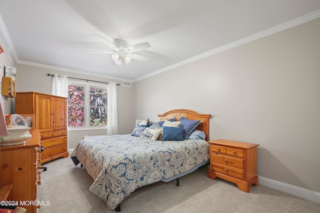 carpeted bedroom featuring ceiling fan and crown molding