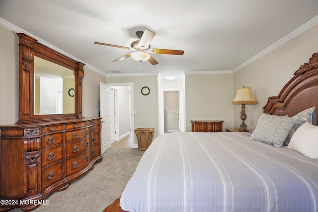 carpeted bedroom featuring ceiling fan and crown molding