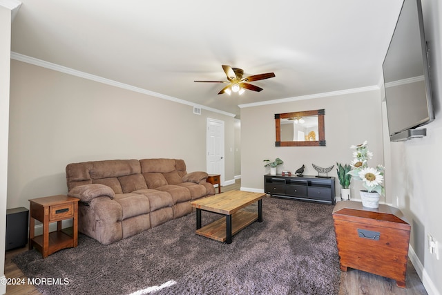 living room featuring dark hardwood / wood-style flooring, ceiling fan, and crown molding