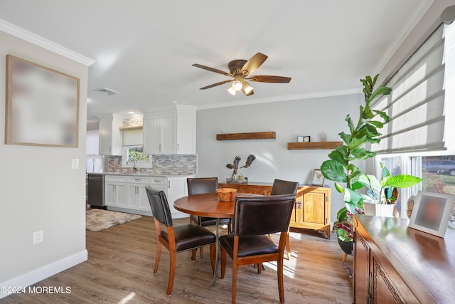 dining space with light hardwood / wood-style floors, ceiling fan, ornamental molding, and sink