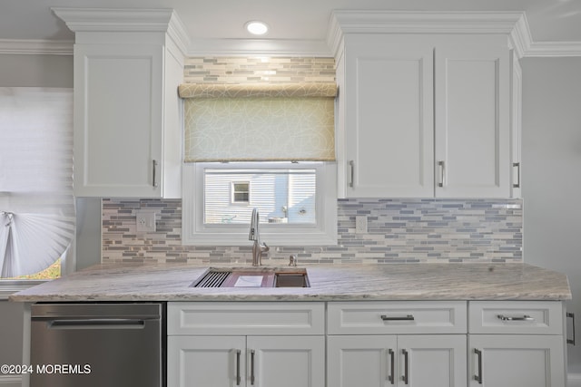 kitchen featuring backsplash, crown molding, sink, light stone countertops, and white cabinetry