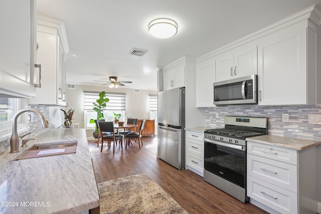 kitchen featuring white cabinets, sink, ceiling fan, dark hardwood / wood-style flooring, and stainless steel appliances