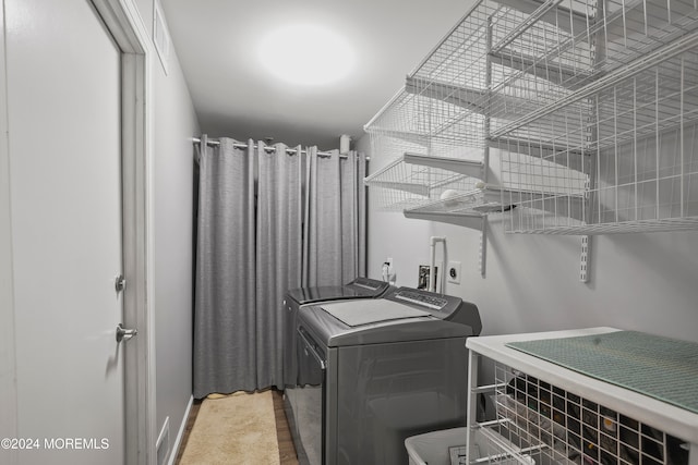 clothes washing area featuring washer and dryer