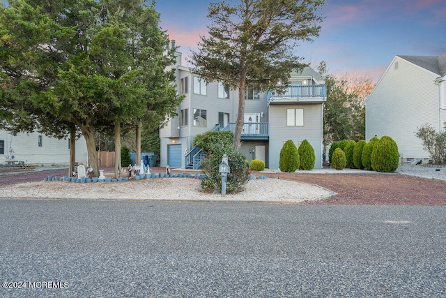 view of front facade featuring a balcony and a garage