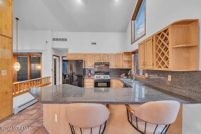 kitchen with sink, a baseboard radiator, a high ceiling, electric stove, and black fridge with ice dispenser