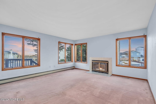 unfurnished living room featuring a high end fireplace, a baseboard radiator, and light colored carpet