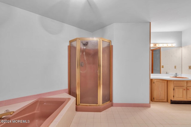 bathroom with tile patterned floors, vanity, and separate shower and tub