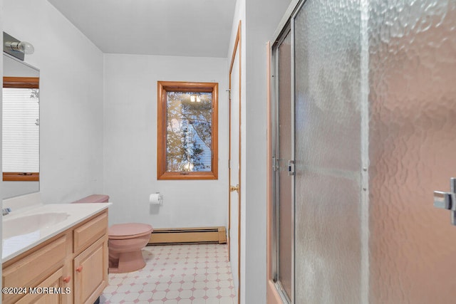 bathroom with vanity, toilet, a shower with door, and a baseboard heating unit