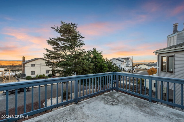 view of balcony at dusk