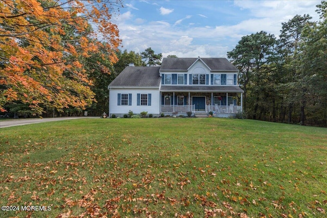 colonial house with covered porch and a front yard