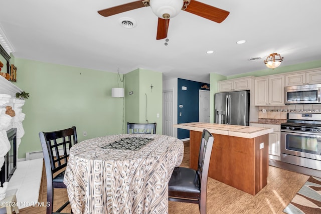 dining space featuring light hardwood / wood-style flooring, baseboard heating, and ceiling fan