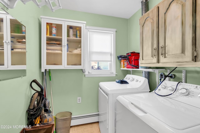 washroom with cabinets, independent washer and dryer, and a baseboard radiator