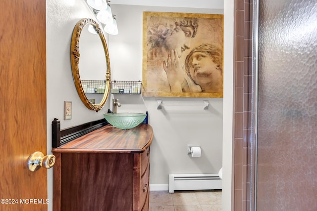 bathroom with tile patterned floors, vanity, and a baseboard heating unit