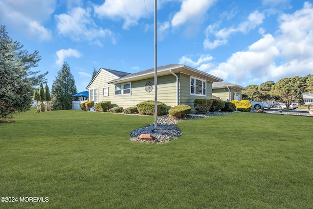 view of home's exterior with a yard