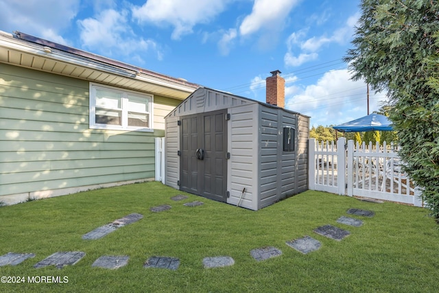 view of outbuilding with a yard